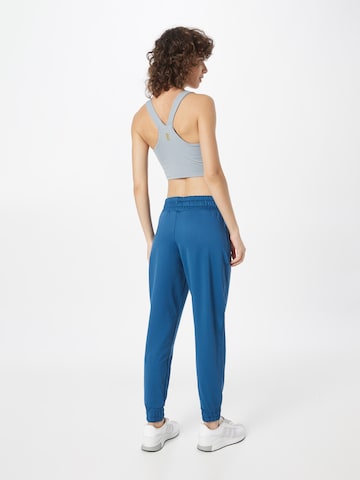 UNDER ARMOUR Tapered Sports trousers 'Meridian' in Blue