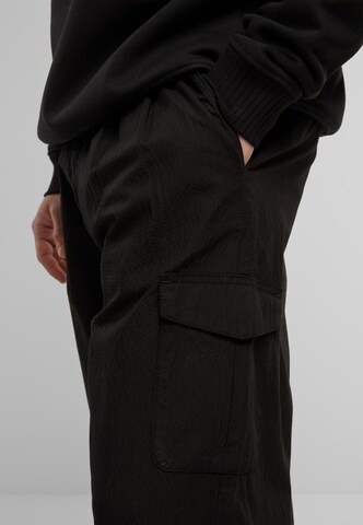 Wide leg Pantaloni cu buzunare de la Urban Classics pe negru