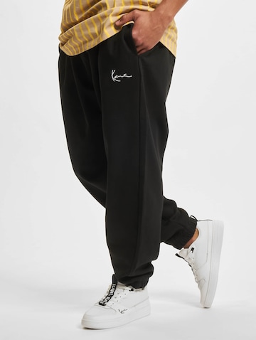 Karl Kani Tapered Pants in Black: front