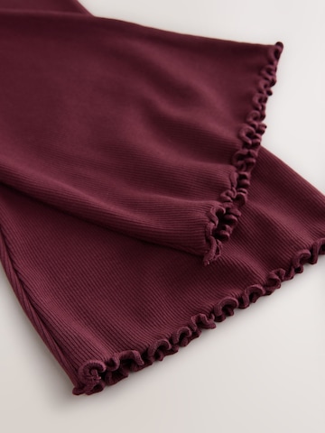Next - Acampanado Leggings en rojo