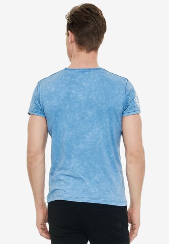 Rusty Neal Cooles T-Shirt mit großem Front- Print in Blau