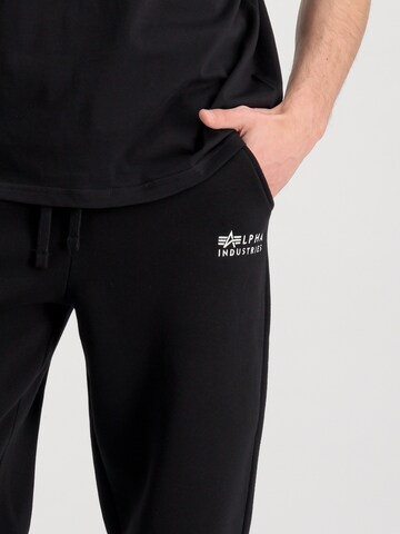 juoda ALPHA INDUSTRIES Siaurėjantis Kelnės