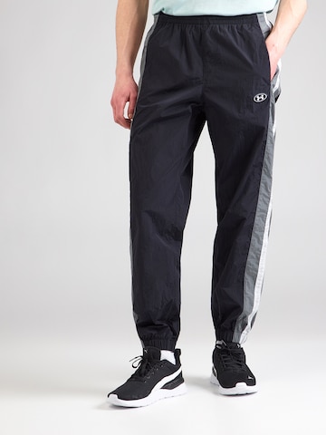 UNDER ARMOUR - Tapered Pantalón deportivo en negro: frente