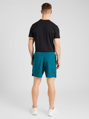 UNDER ARMOUR Regular Workout Pants 'Gewebte Wdmk' in Green