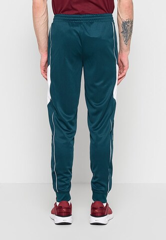 Effilé Pantalon de sport PUMA en vert : derrière