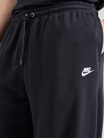 Nike Sportswear Loosefit Housut 'CLUB' värissä musta