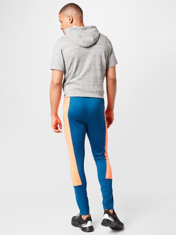 UNDER ARMOUR Skinny Športové nohavice 'Challenger' - Modrá