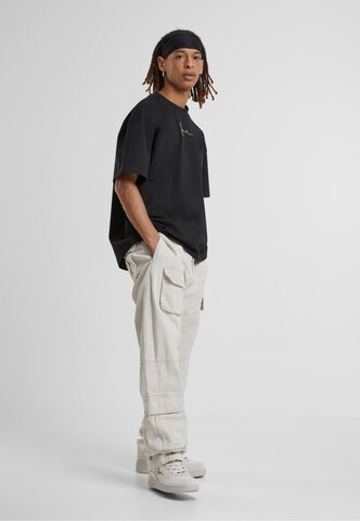 Karl Kani Regular Cargo trousers in Beige
