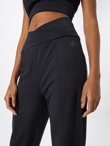 CURARE Yogawear Zwężany krój Spodnie sportowe w kolorze czarny