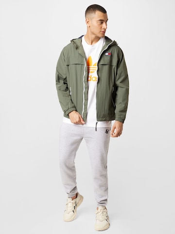 Tommy Jeans Between-Season Jacket 'Chicago' in Green