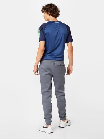 Tapered Pantaloni sportivi di new balance in grigio