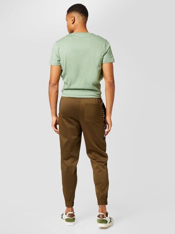 PUMA Tapered Sporthose in Grün