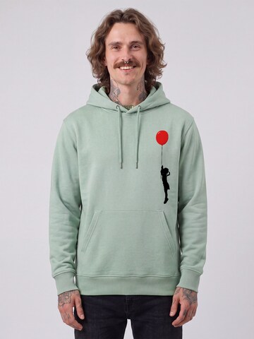 Felpa 'Mädchen mit Luftballon' di Watapparel in verde: frontale