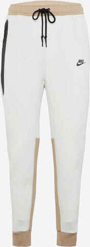 Nike Sportswear - Pantalón 'TECH FLEECE' en beige: frente