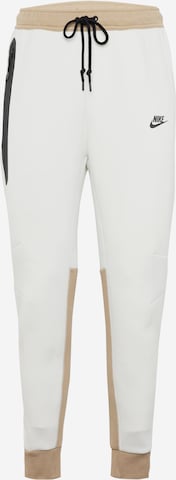 Nike Sportswear Zúžený Kalhoty 'TECH FLEECE' – béžová: přední strana