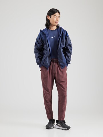 NIKE Tapered Sportbyxa 'UNLIMITED' i röd