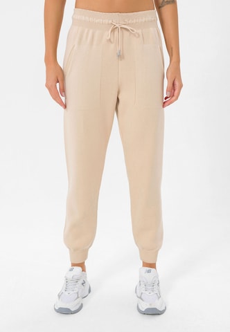 Jimmy Sanders Tapered Workout Pants in Beige: front