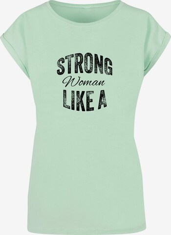 Merchcode T-Shirt 'WD - Strong Like A Woman' in Grün: predná strana