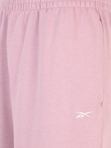 Reebok Zwężany krój Spodnie sportowe w kolorze różowy