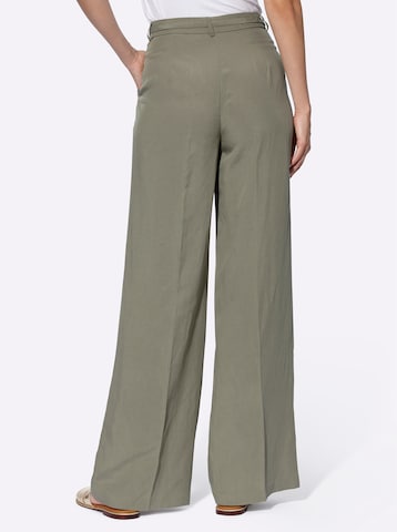 Wide leg Pantaloni con piega frontale di heine in verde