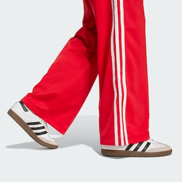 ADIDAS ORIGINALS Loose fit Trousers 'Adicolor Firebird' in Red