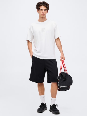 NIKE Loosefit Παντελόνι φόρμας 'NAC FLC' σε μαύρο
