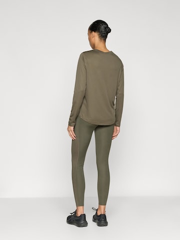 ASICS Skinny Sportovní kalhoty – zelená