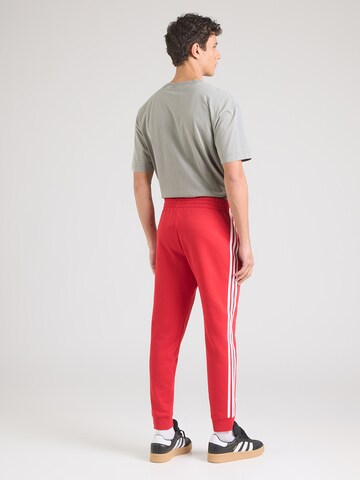 Effilé Pantalon ADIDAS ORIGINALS en rouge