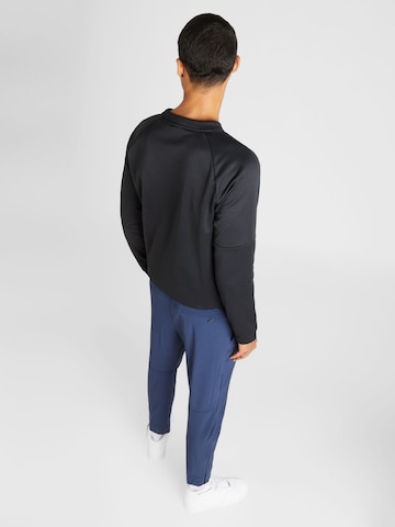 Effilé Pantalon de sport 'UNLIMITED' NIKE en bleu