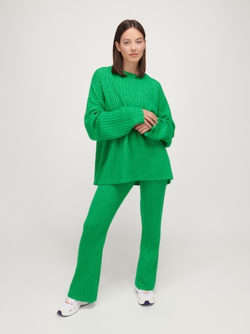 UNFOLLOWED x ABOUT YOU Flared Trousers 'COMFY' in Green