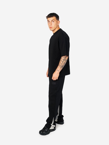 Loosefit Pantaloni sportivi 'AOF FLARED JOGGER' di ATELIER OF FAITH in nero