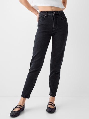 Bershka Tapered Jeans in Black: front