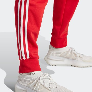 ADIDAS ORIGINALS Tapered Trousers 'Adicolor Classics' in Red