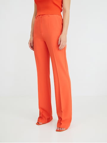 ABOUT YOU x Iconic by Tatiana Kucharova Flared Pants 'Jillian' in Orange: front