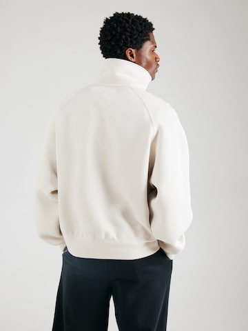 Sweat-shirt 'TCH FLC' Nike Sportswear en beige : derrière