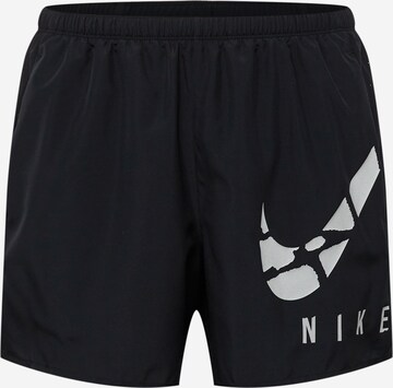 NIKE Regular Sports trousers in Black: front