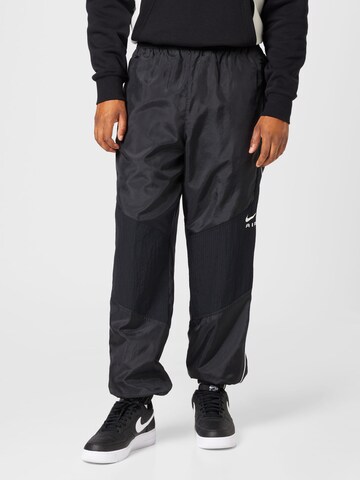 Nike Sportswear Tapered Pants in Black: front