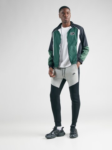 Nike Sportswear Zwężany krój Spodnie 'TCH FLC' w kolorze czarny