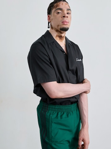 ADIDAS ORIGINALS Tapered Trousers in Green