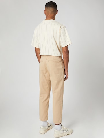 Regular Pantalon à pince Kosta Williams x About You en beige