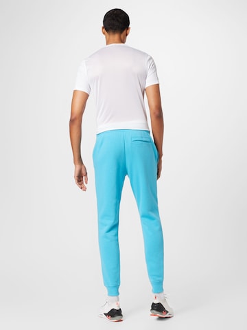 UNDER ARMOURTapered Sportske hlače 'Rival' - plava boja