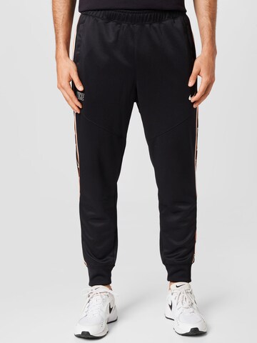 Nike Sportswear Tapered Trousers in Black: front