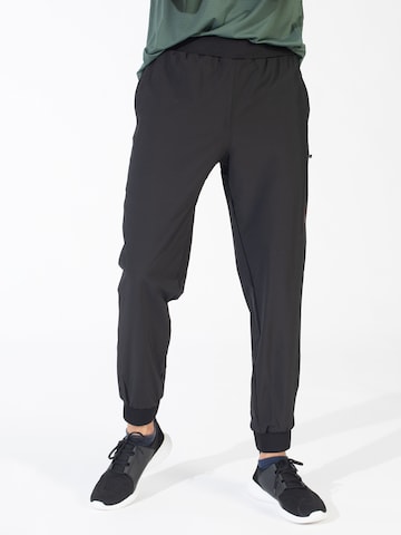 Spyder Tapered Workout Pants in Black: front