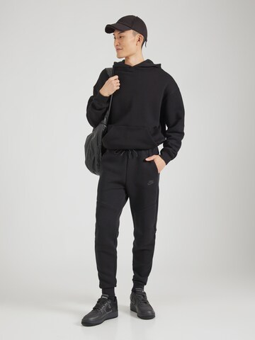 Nike Sportswear Tapered Παντελόνι 'TCH FLC' σε μαύρο