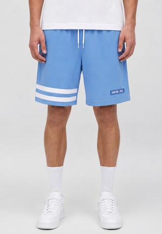 Unfair Athletics Regular Trousers 'DMWU' in Blue: front