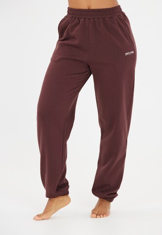 Athlecia Tapered Sportbroek 'Giannis' in Bruin: voorkant