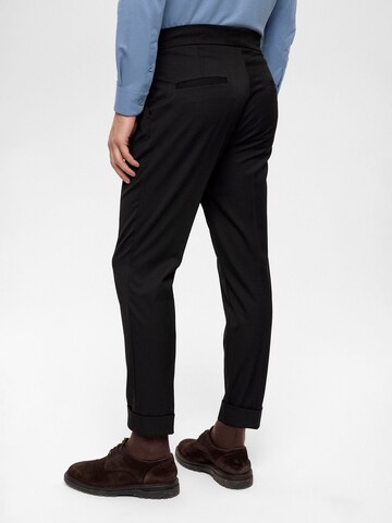 Antioch Tapered Pleat-front trousers in Black