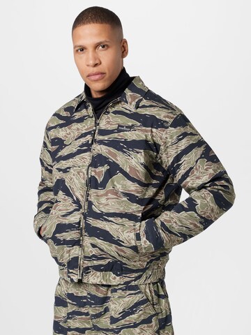 BDG Urban Outfitters Between-Season Jacket 'TIGER CAMO' in Green: front