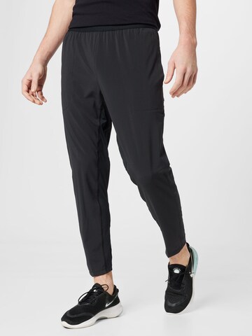 NIKE Tapered Workout Pants in Black: front