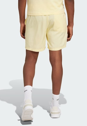 ADIDAS SPORTSWEAR Regular Workout Pants 'Essentials Chelsea' in Yellow